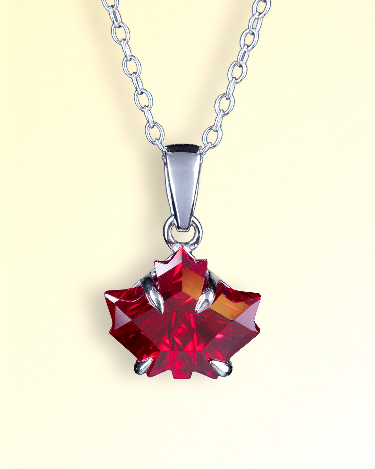 Snow & Stones Jewelry sterling silver necklace featuring a red maple leaf-cut gemstone.